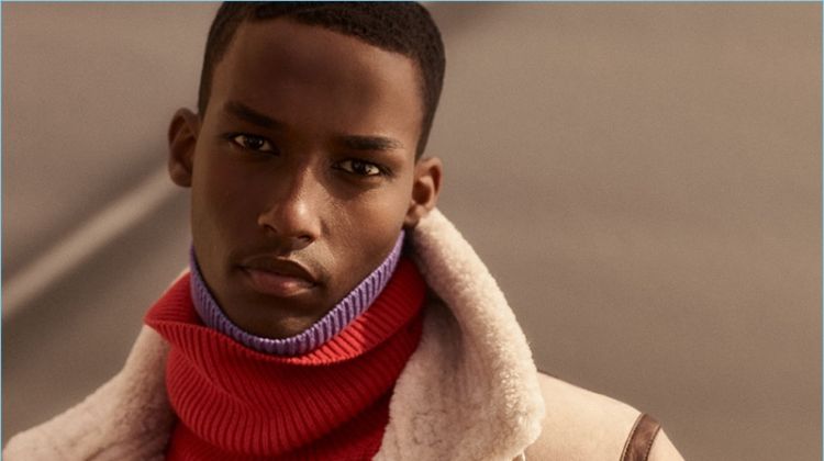 Mahad Musse dons a shearling aviator jacket and knit turtleneck sweaters from Zara Man.