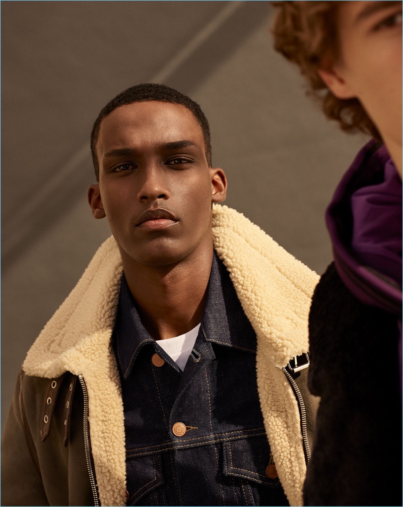 Model Mahad Musse wears khaki aviator jacket and raw denim jacket from Zara Man.