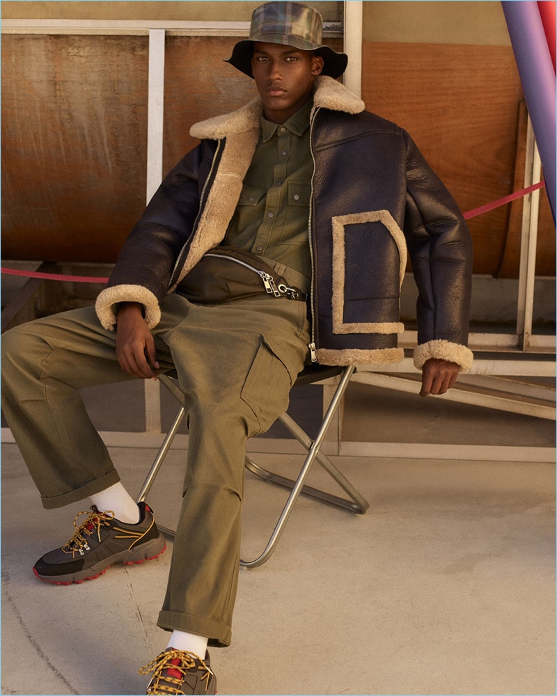 A fashionable vision, Mahad Musse rocks a double-sided jacket, khaki shirt, cargo pants, cross body bag, checked bucket hat, and sneakers. » Mahad Musse Makes a 'Shearling Statement' for Zara A fashionable vision, Mahad Musse rocks a double-sided jacket, khaki shirt, cargo pants, cross body bag, checked bucket hat, and sneakers.