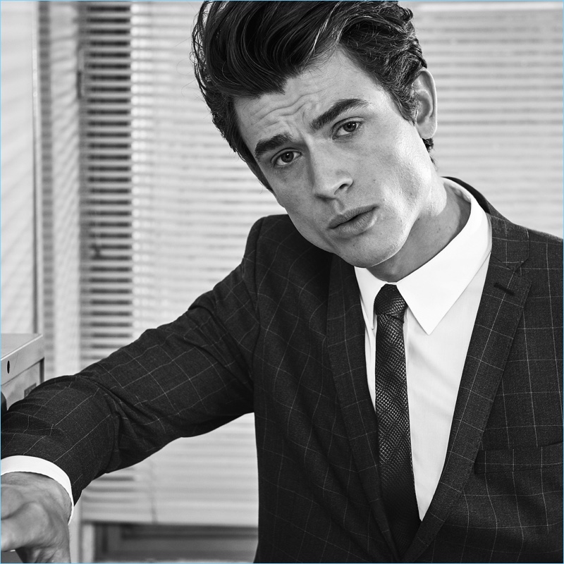 Posing for a photo, Luc van Geffen sports a windowpane print suit jacket from s.Oliver Black Label.