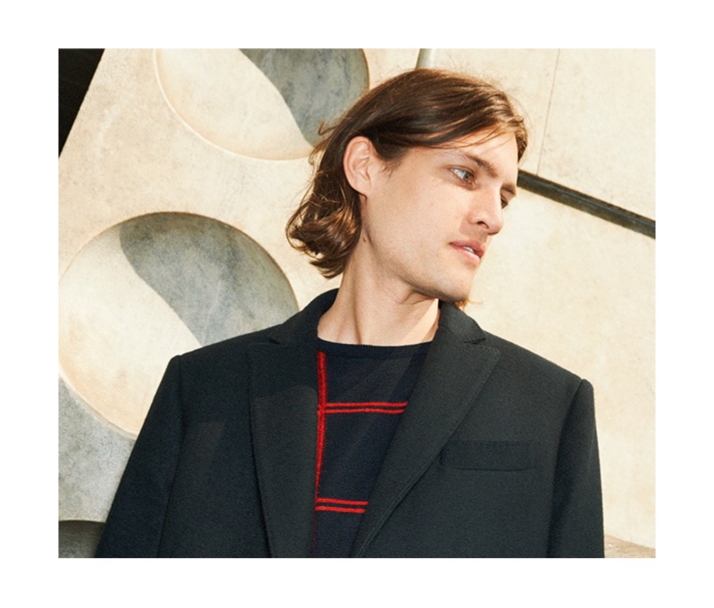 Canadian model Marcel Castenmiller wears a 8 by YOOX coat and graphic check sweater.