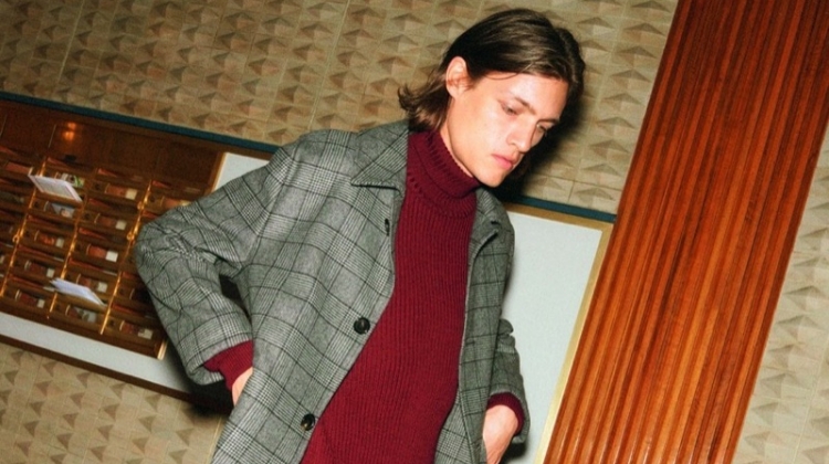 Marcel Castenmiller dons a 8 by YOOX ribbed turtleneck sweater and casual trousers.