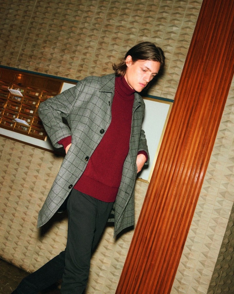 Marcel Castenmiller dons a 8 by YOOX ribbed turtleneck sweater and casual trousers.