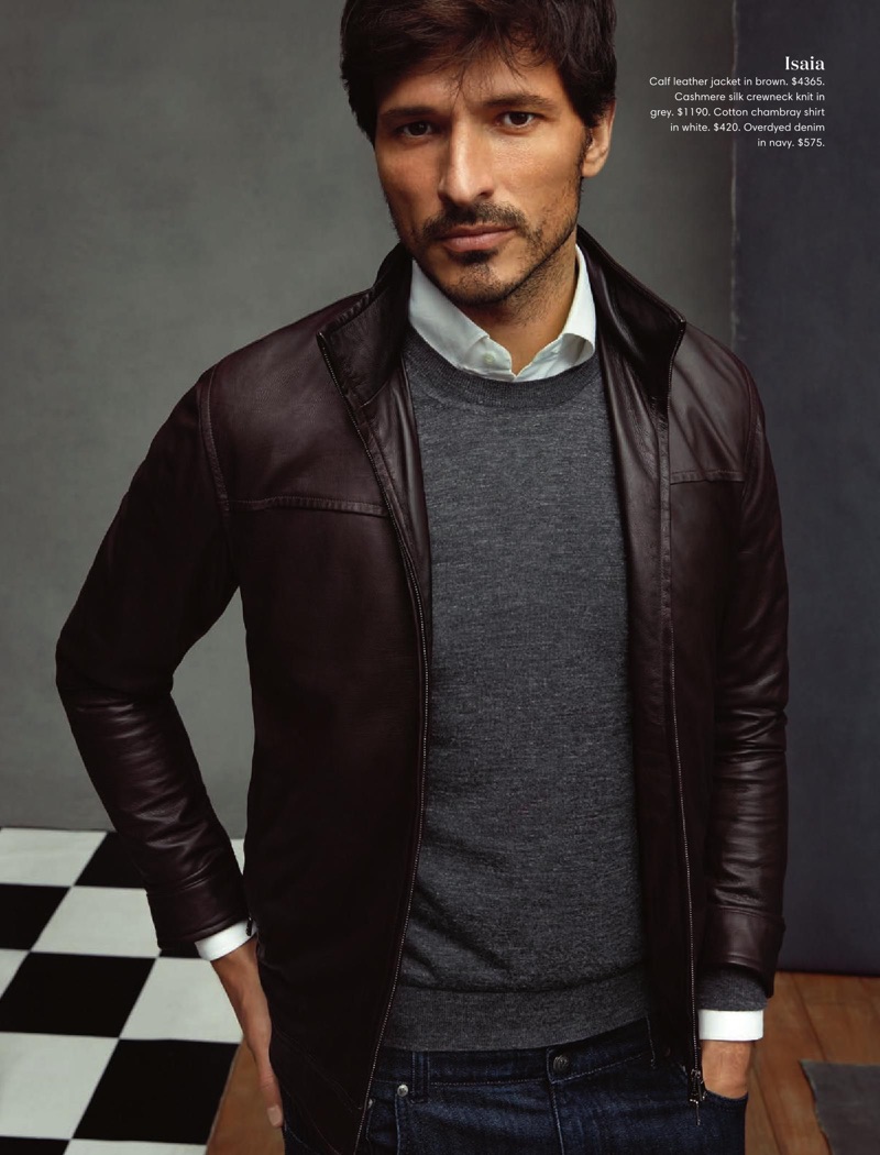 Andres Velencoso wears an ISAIA brown leather jacket with a cashmere sweater, chambray shirt, and denim jeans.