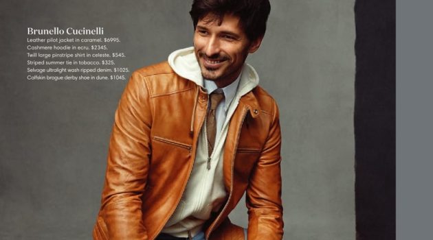 Andres Velencoso Inspires in Designer Looks for Holt Renfrew All smiles, Andres Velencoso dons a Brunello Cucinelli caramel leather jacket, cashmere hoodie, pinstripe shirt, striped tie, ripped jeans, and brogue derby shoes.
