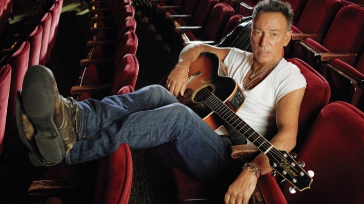 Kicking his feet back, Bruce Springsteen sports an AllSaints t-shirt.