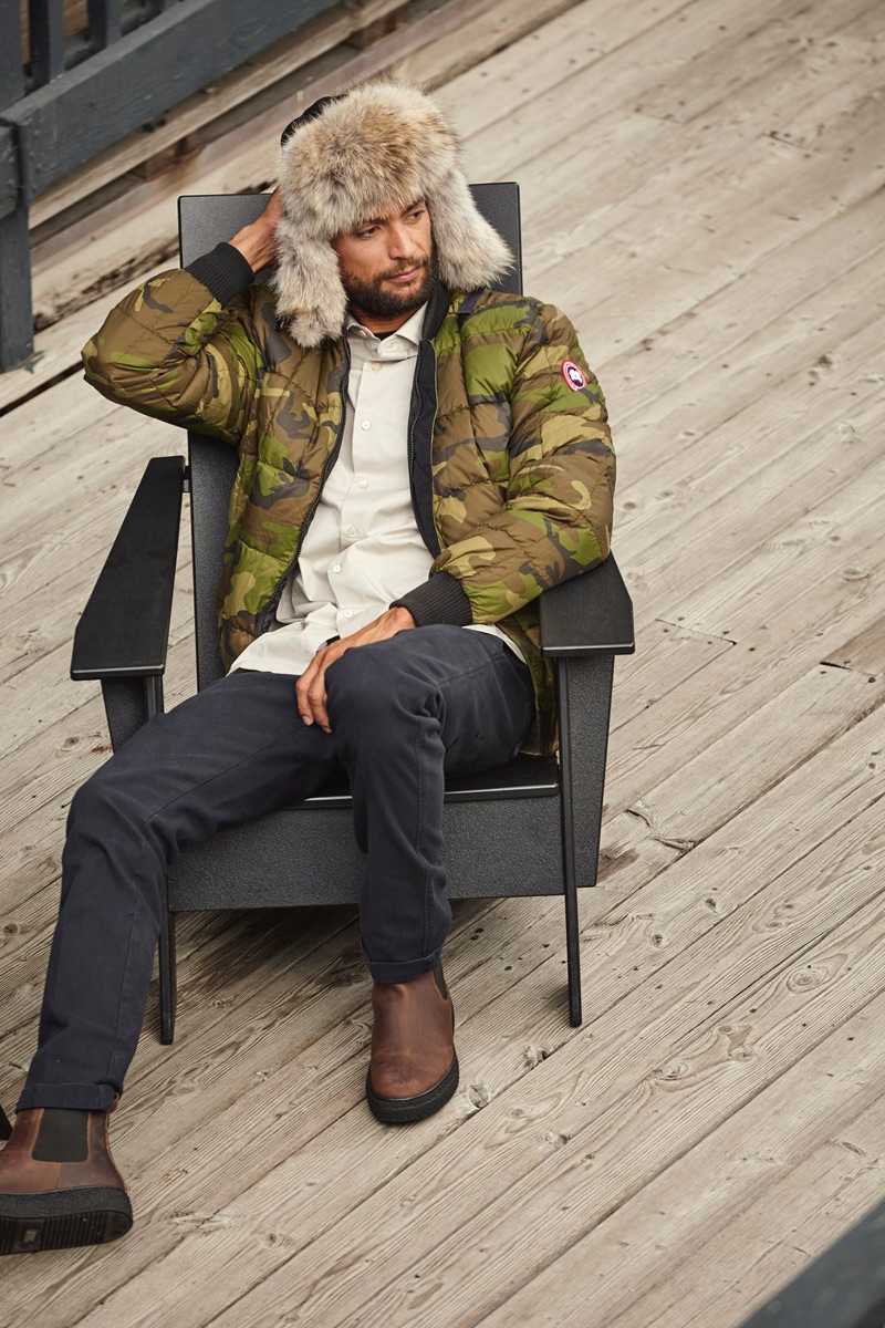 Stealing a moment to relax, Steven sports Canada Goose's Fraser Reversible Bomber Jacket.