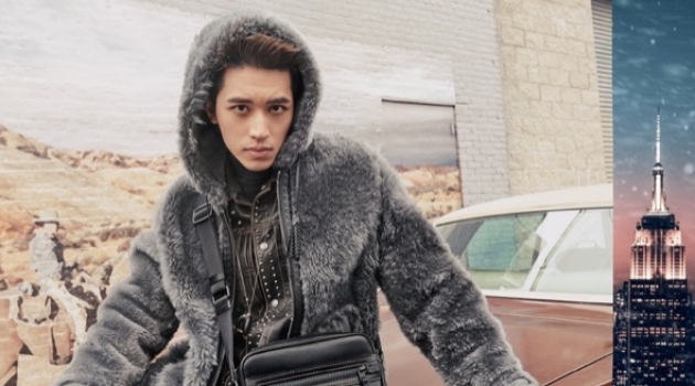 Coach Features New Must-Haves in Holiday '18 Campaign Timmy Xu dons a reversible shearling hoodie in dark grey for Coach's holiday 2018 campaign.