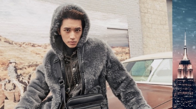 Timmy Xu dons a reversible shearling hoodie in dark grey for Coach's holiday 2018 campaign.