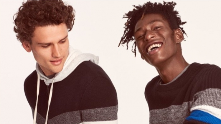 Models Simon Nessman and Shenai Gist sport color blocked sweaters from Express.