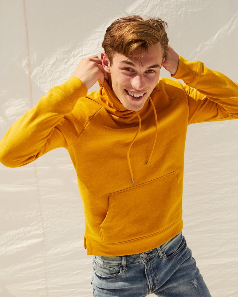 Kit Butler rocks a yellow fleece funnel neck hoodie from Express.