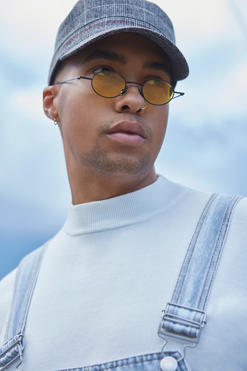 Isak wears shirt Zara, overalls Cheap Monday, hat Reserved, and sunglasses Komono.