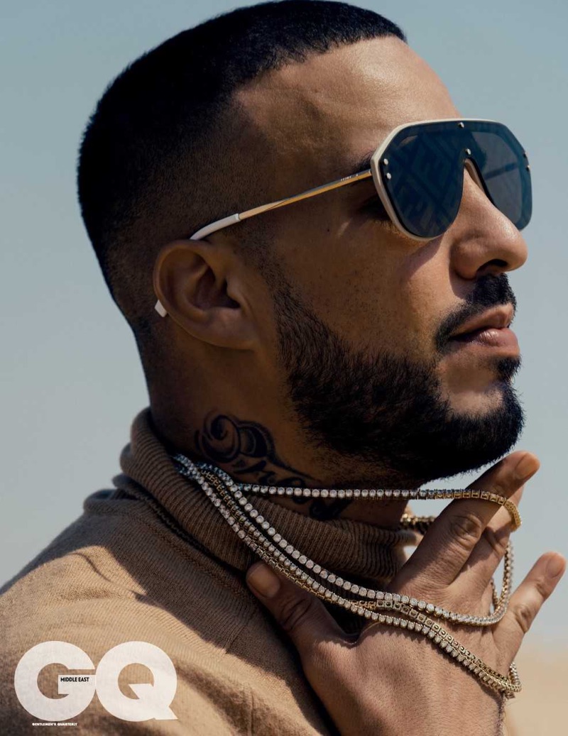 Rapper French Montana rocks Fendi sunglasses with an AMI turtleneck sweater.