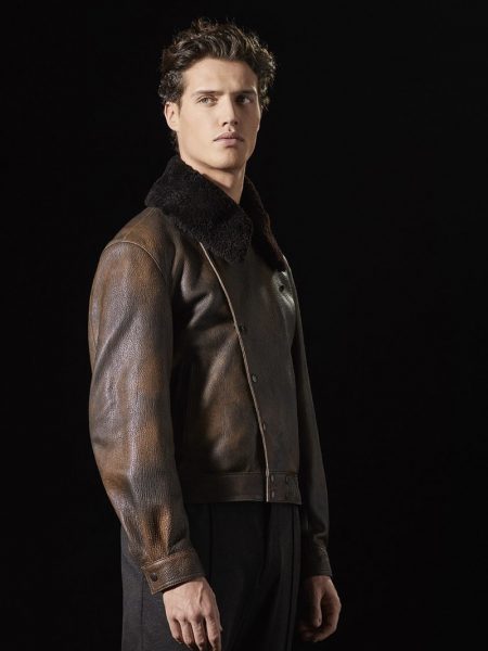Front and center, Federico Novello sports a brown leather jacket with a shearling collar by Giorgio Armani.