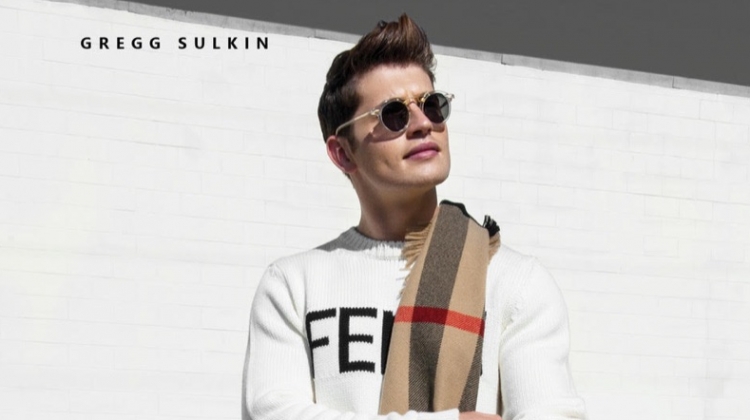 Stepping out, Gregg Sulkin wears a Fendi sweater, Burberry scarf, and G-Star Raw houndstooth pants.