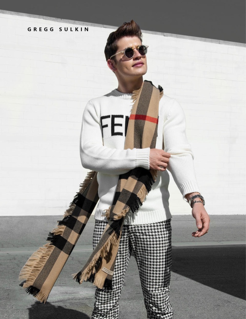 Stepping out, Gregg Sulkin wears a Fendi sweater, Burberry scarf, and G-Star Raw houndstooth pants.