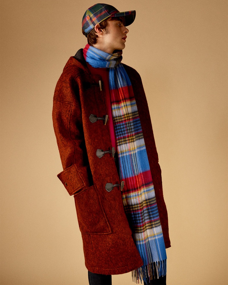 Embracing tartan, Lennon Gallagher models a red duffle coat by Zara Man.