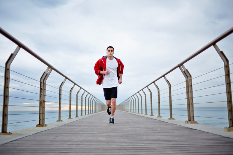 Man running in hooded jacket