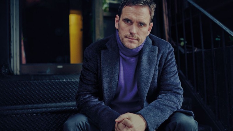 Actor Matt Dillon wears a Brioni overcoat, Berluti turtleneck sweater, and Prada trousers.