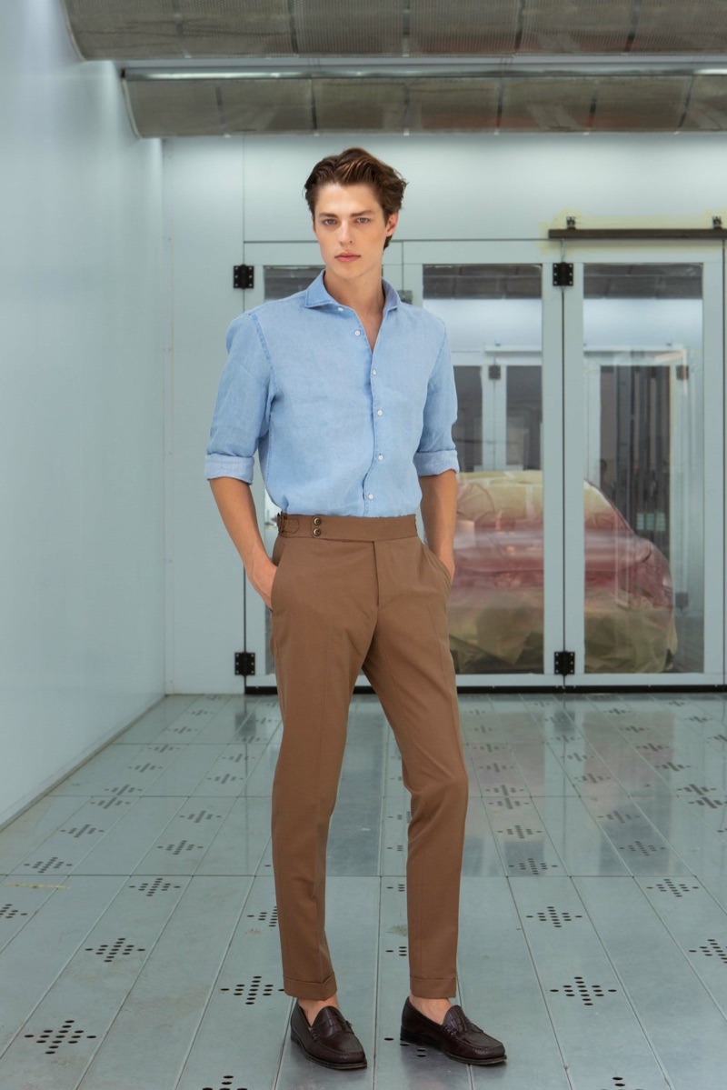 A smart vision, Brodie Scott dons brown trousers from PT Pantaloni Torino.