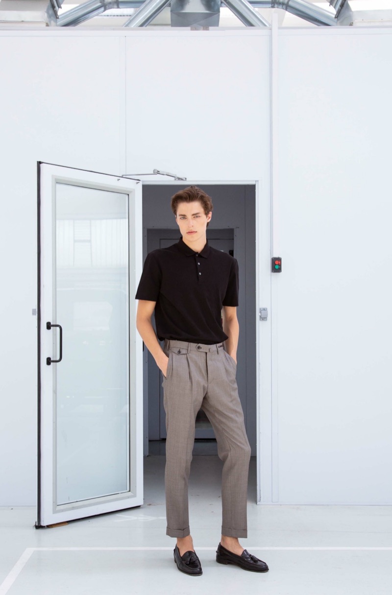 Model Brodie Scott sports PT Pantaloni Torino's pleated trousers with an essential polo.