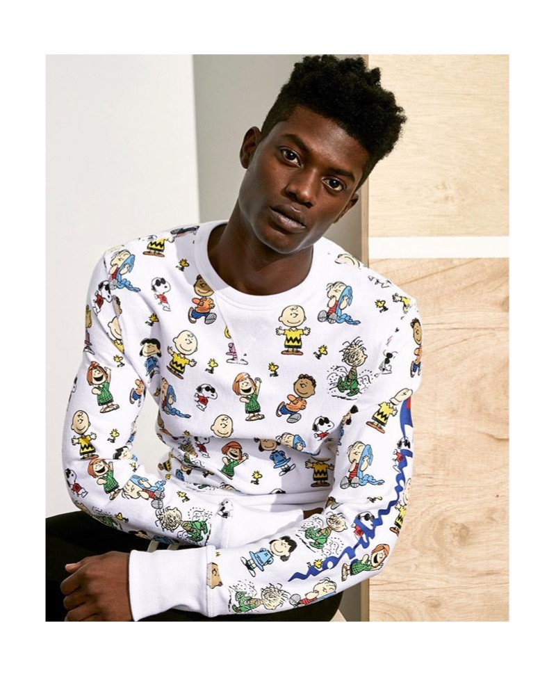 Embracing an all-over print, Yahrock Bates wears a Todd Snyder + Champion x Peanuts sweatshirt in white.