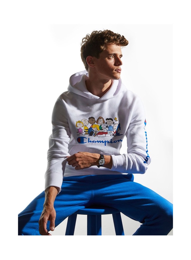 Dutch model Jordy Baan sports a Todd Snyder + Champion x Peanuts hoodie in white.