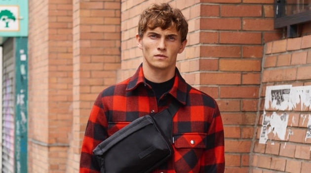 American Standard: Luc Defont-Saviard Dons New Sandro Essentials Luc Defont-Saviard sports a Sandro red and black checked jacket lined with faux sheepskin.