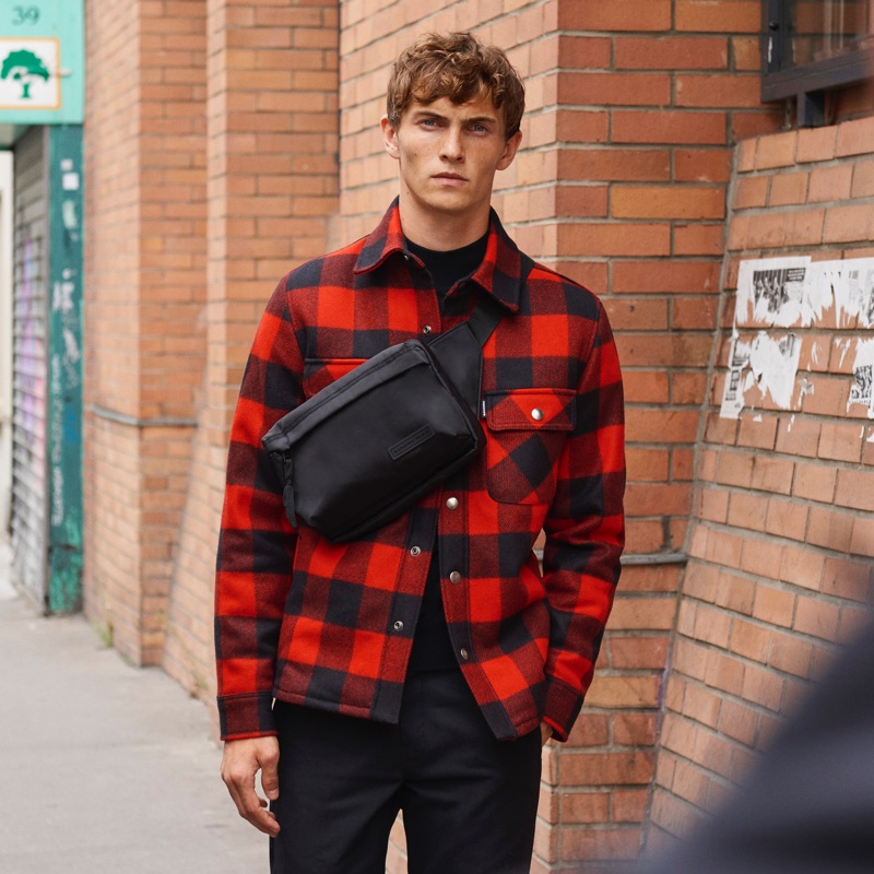 Luc Defont-Saviard sports a Sandro red and black checked jacket lined with faux sheepskin.