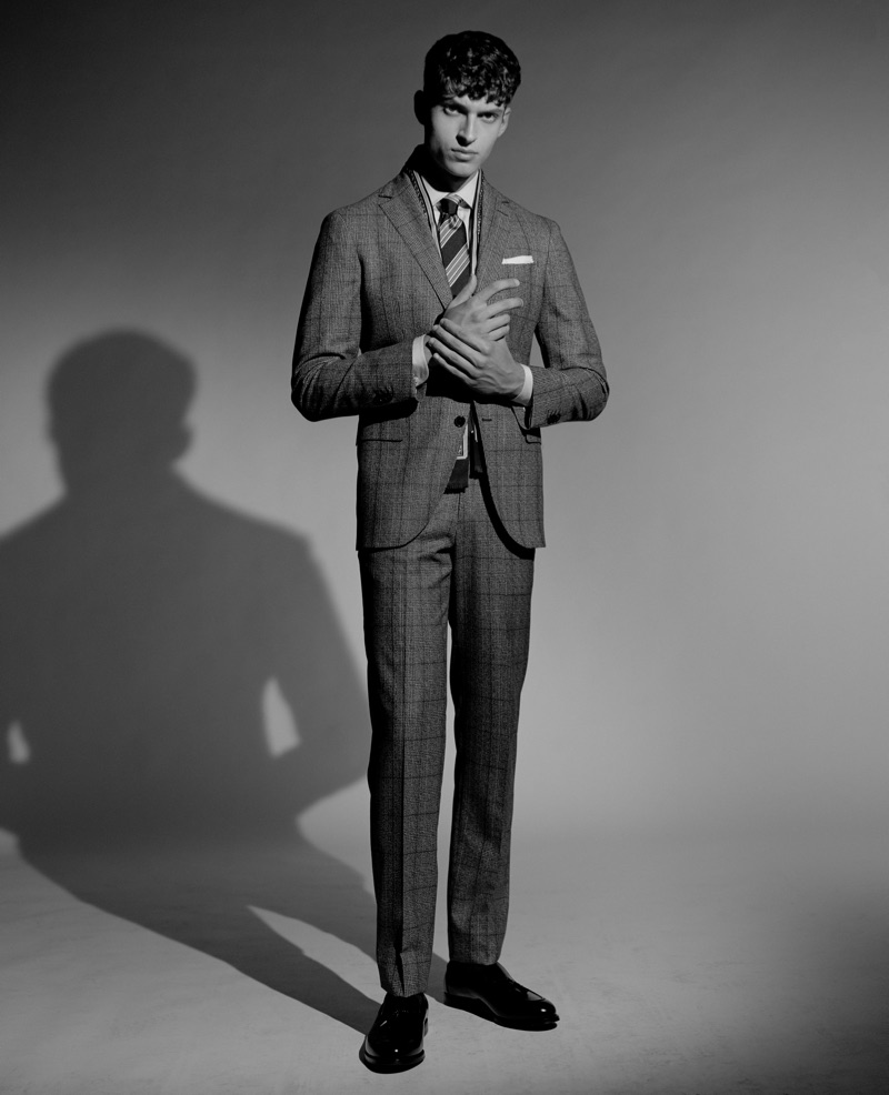 Azim Osmani wears a Boggi Milano suit and shirt with a tie and shoes by Ermenegildo Zegna.