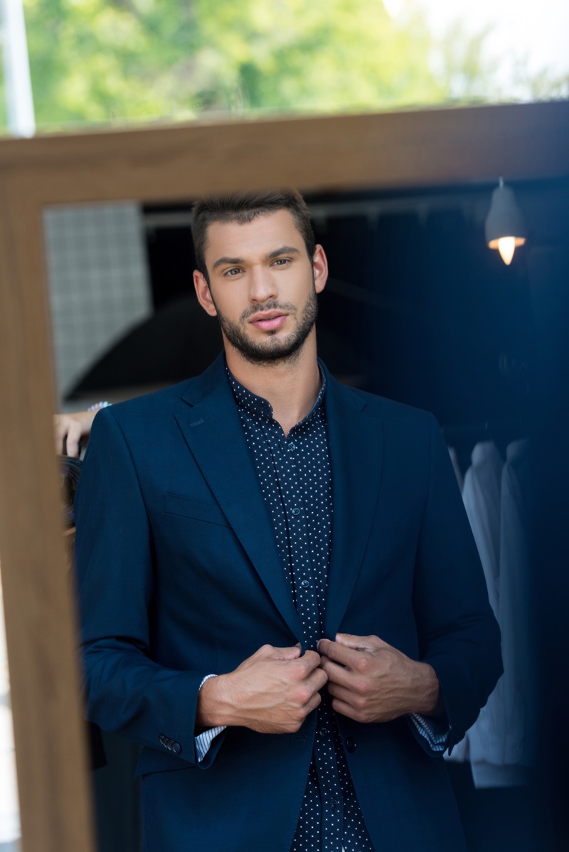 Man Getting Dressed in Mirror