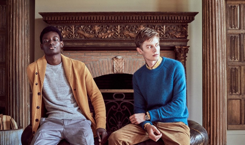 Left to Right: Youssouf Bamba dons a brass yellow shawl cardigan sweater, grey cashmere sweater, and light grey trousers. Janis models a bright blue Italian brushed wool sweater and caramel-colored 5-pocket pants.