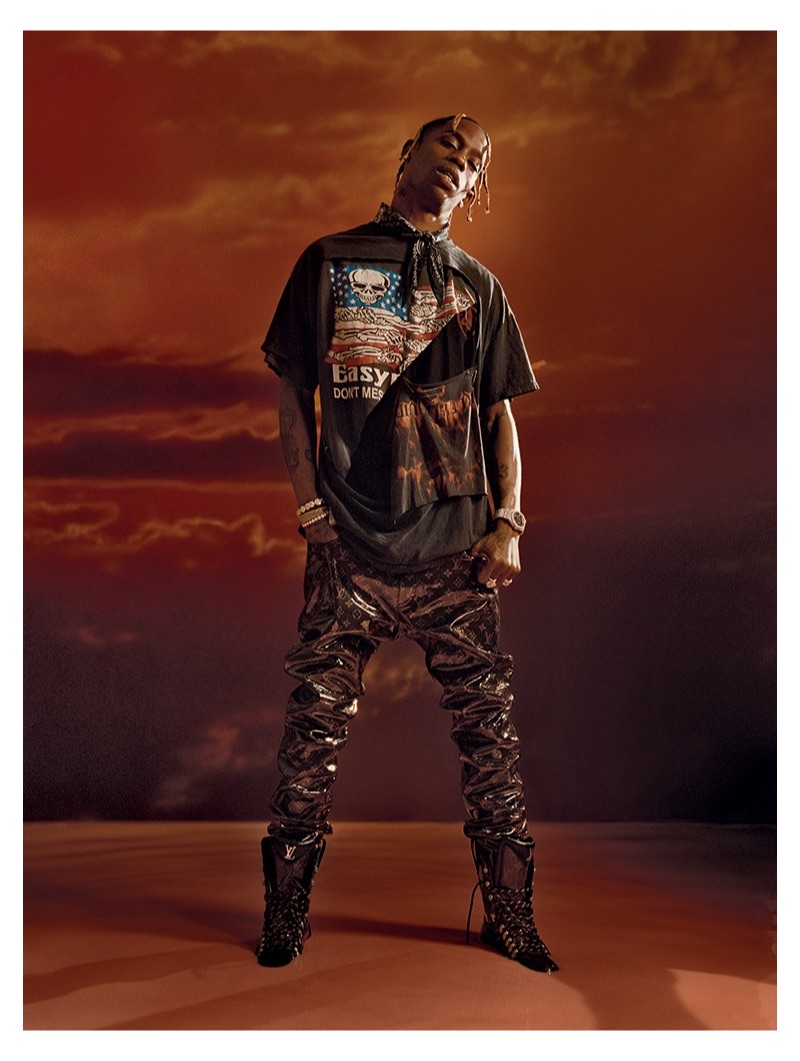 Front and center, Travis Scott sports Louis Vuitton pants, an Alexander Wang bandana, and a vintage t-shirt.