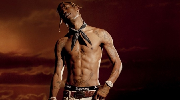 Travis Scott Covers L'Officiel Hommes Italia, Talks Tour Merch Posing for a new photo shoot, Travis Scott goes shirtless in a Palm Angels belt and trousers with an Alexander Wang bandana.