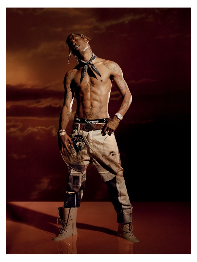 Posing for a new photo shoot, Travis Scott goes shirtless in a Palm Angels belt and trousers with an Alexander Wang bandana.
