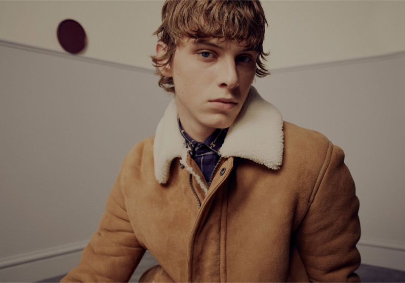 Serge Sergeev dons a shearling coat and checked shirt by Valentino.