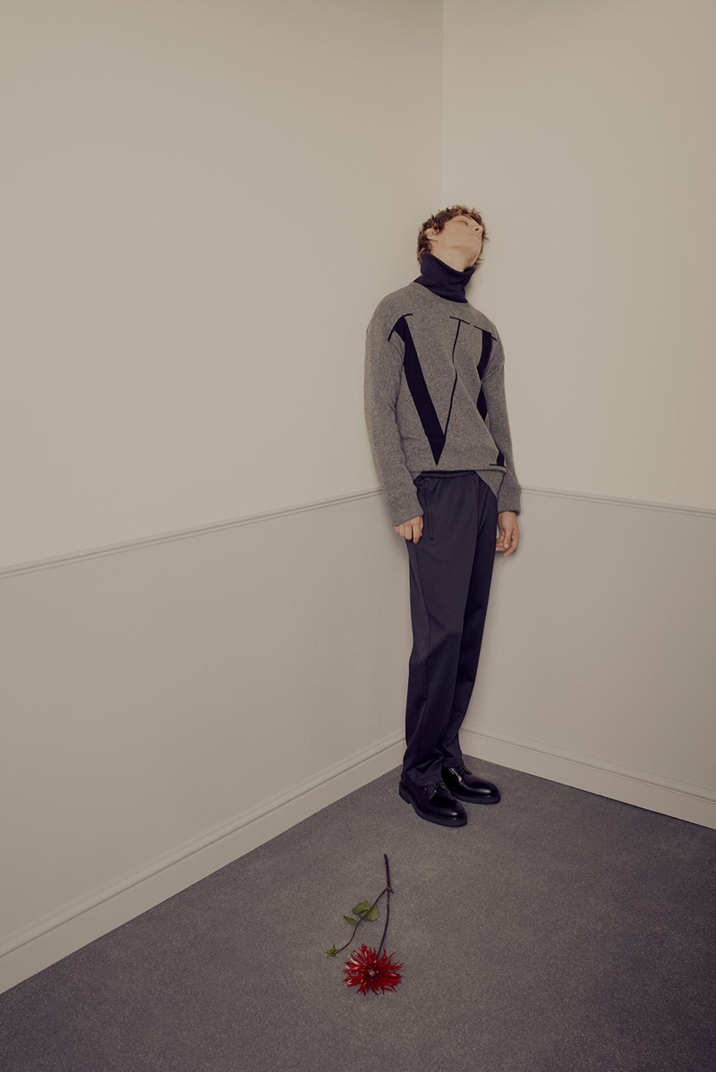 Directed to the corner, Serge Sergeev wears a Valentino sweater, logo-print turtleneck sweater, track pants, and leather desert boots. » Serge Sergeev is the Valentino Man for Matches Fashion Directed to the corner, Serge Sergeev wears a Valentino sweater, logo-print turtleneck sweater, track pants, and leather desert boots.