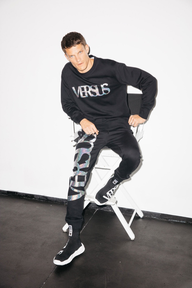 Danny Beauchamp wears a sweatshirt and joggers by Versus Versace.