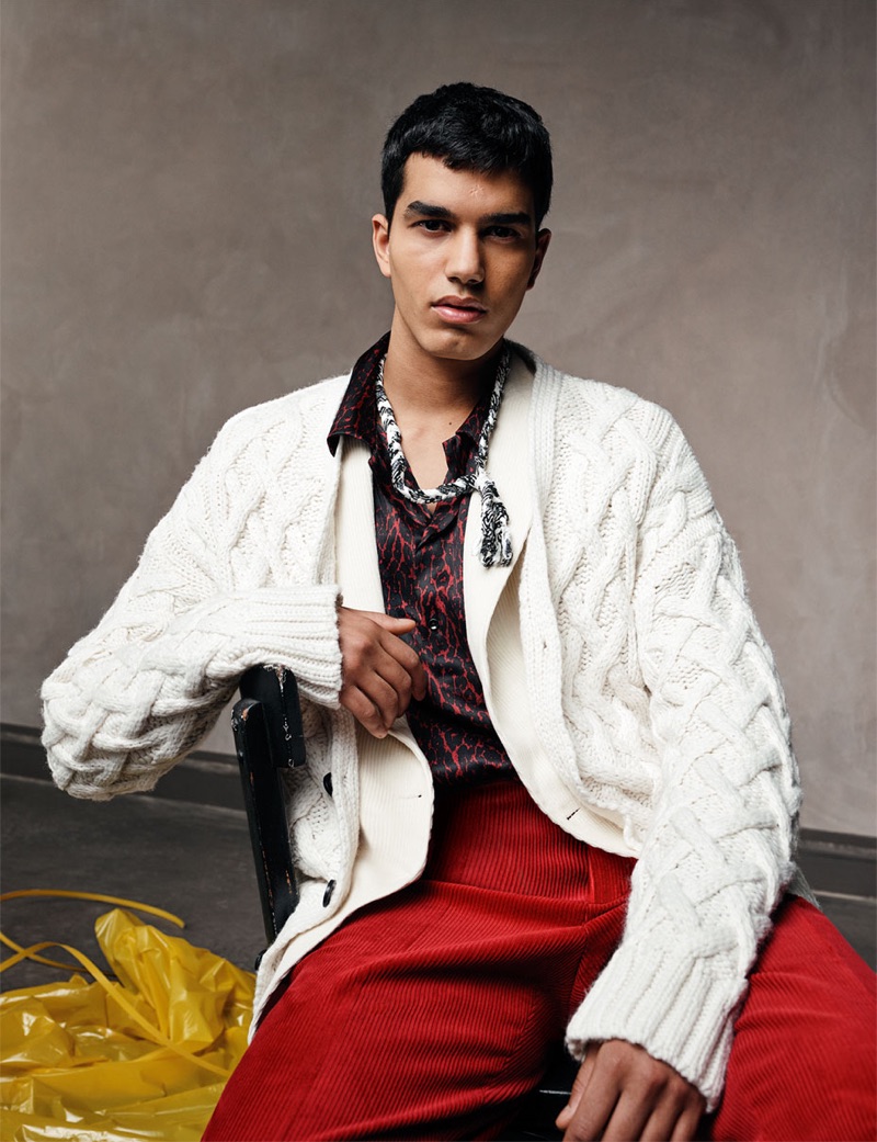 Saif Khorchid sports a cable-knit cardigan sweater with a leopard print shirt and red corduroy pants from Zara Man.