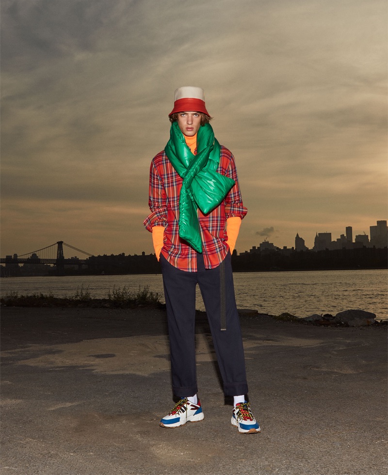 Sporting a red tartan shirt, Theo Ford also wears a Zara Man puffer scarf.