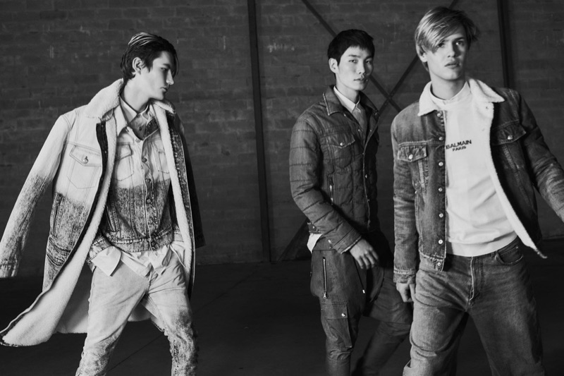 Sporting denim, Elias de Poot, Jo Wonil, and Emil Wikstrom wear denim from Balmain's pre-fall 2019 men's collection.