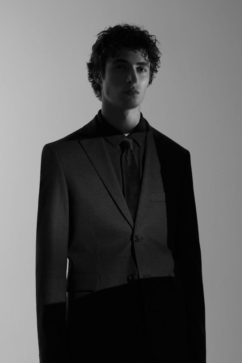 Oscar Kindelan dons a black on black suit number from COS.