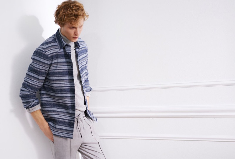 Model Sven de Vries wears a Club Monaco cashmere turtleneck, striped overshirt, and elastic pintuck pants.