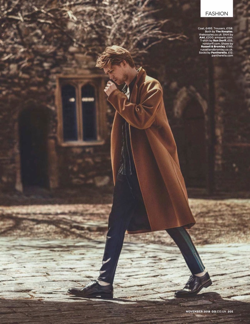 Going for a stroll, Joe Alwyn wears a coat and trousers by The Kooples. He also dons an AMI shirt, Ron Dorff t-shirt, and Russell & Bromley shoes.