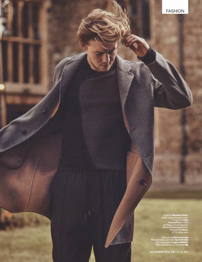 Starring in a photo shoot, Joe Alwyn wears a Massimo Dutti coat, Kiko Kostadinov sweater, and BOSS trousers.