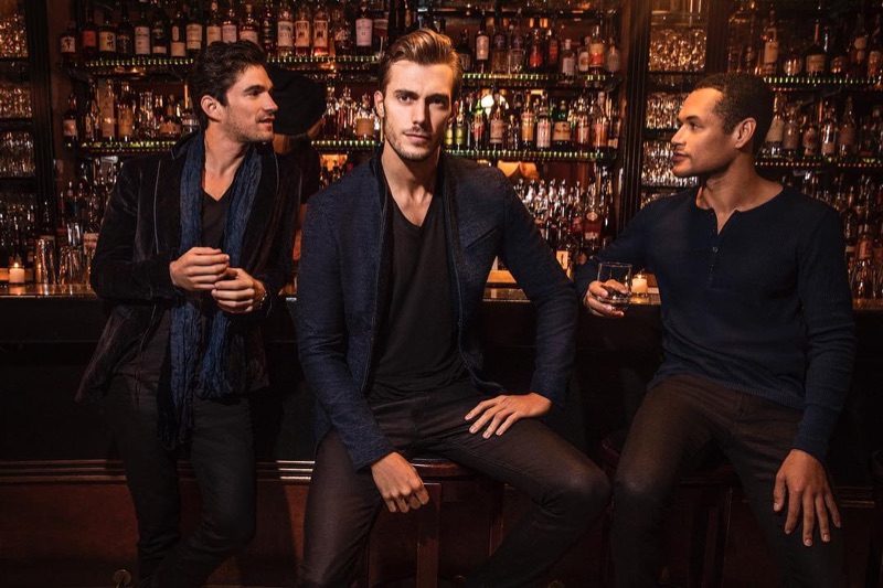 Models David Sanz, Federico Cola, and Joshua Milligan Robinson don holiday 2018 style from John Varvatos.