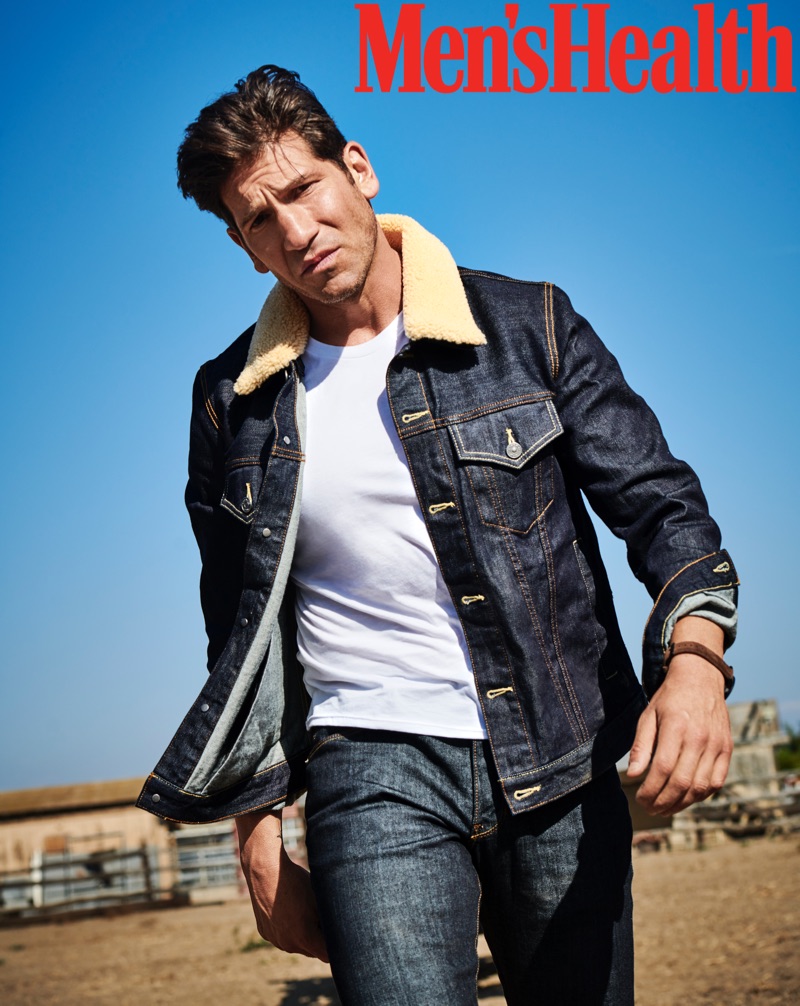 Actor Jon Bernthal sports a Coach 1941 denim jacket, Michael Kors t-shirt, Double Eleven jeans, and an Emporio Armani watch.