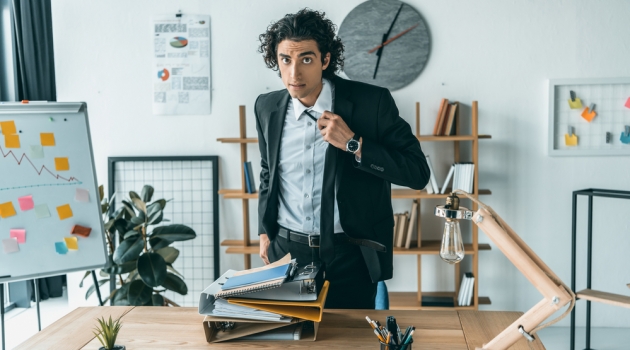 7 Simple Ways You Can Easily Clean Your Ties Man Tying Tie in Office