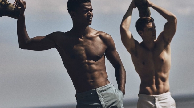 O'Shea Robertson & Edward Wilding Take to the Beach in Orlebar Brown Flexing for the camera, models O'Shea Robertson and Edward Wilding rock swimwear by Orlebar Brown.
