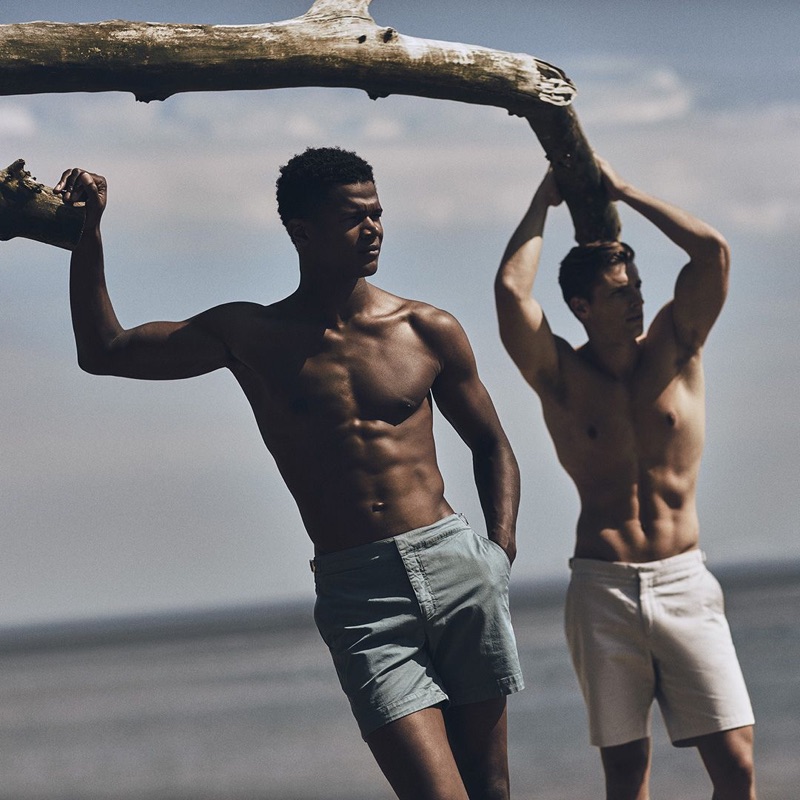 Flexing for the camera, models O'Shea Robertson and Edward Wilding rock swimwear by Orlebar Brown.